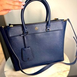 Navy medium sized Tory Burch handbag with shoulder strap.